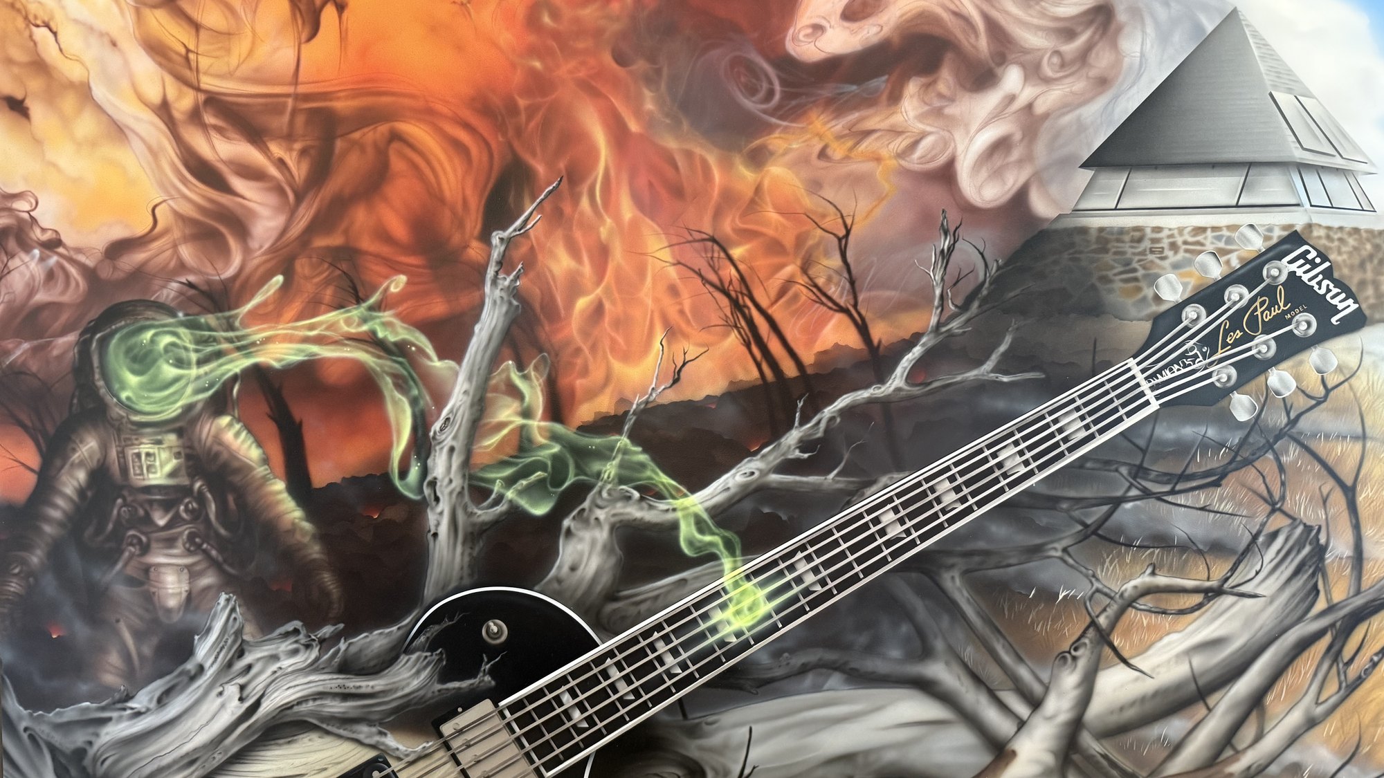 The Locksley half of the artwork: bushfire, burnt trees, a Les Paul and a figure in a spacesuit