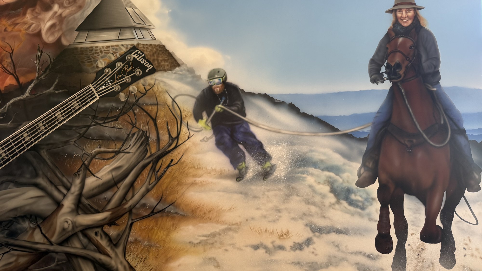 The Mt Buller half of the artwork: the house, a skier and a rider crossing the snow