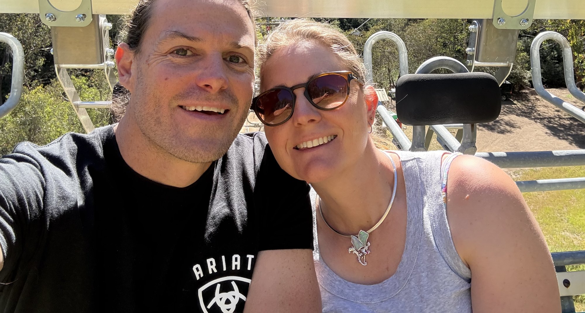 Mark and Leah Follett on a chairlift at Mt Buller