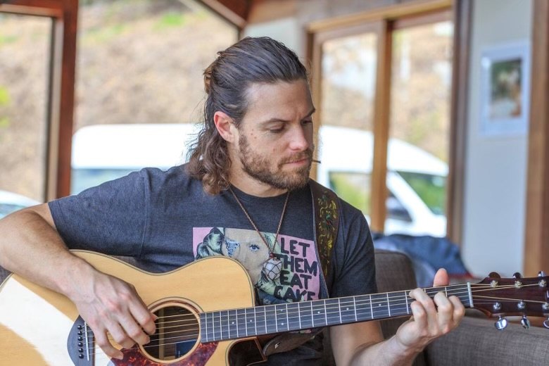 Mark Follett playing a twelve string acoustic guitar