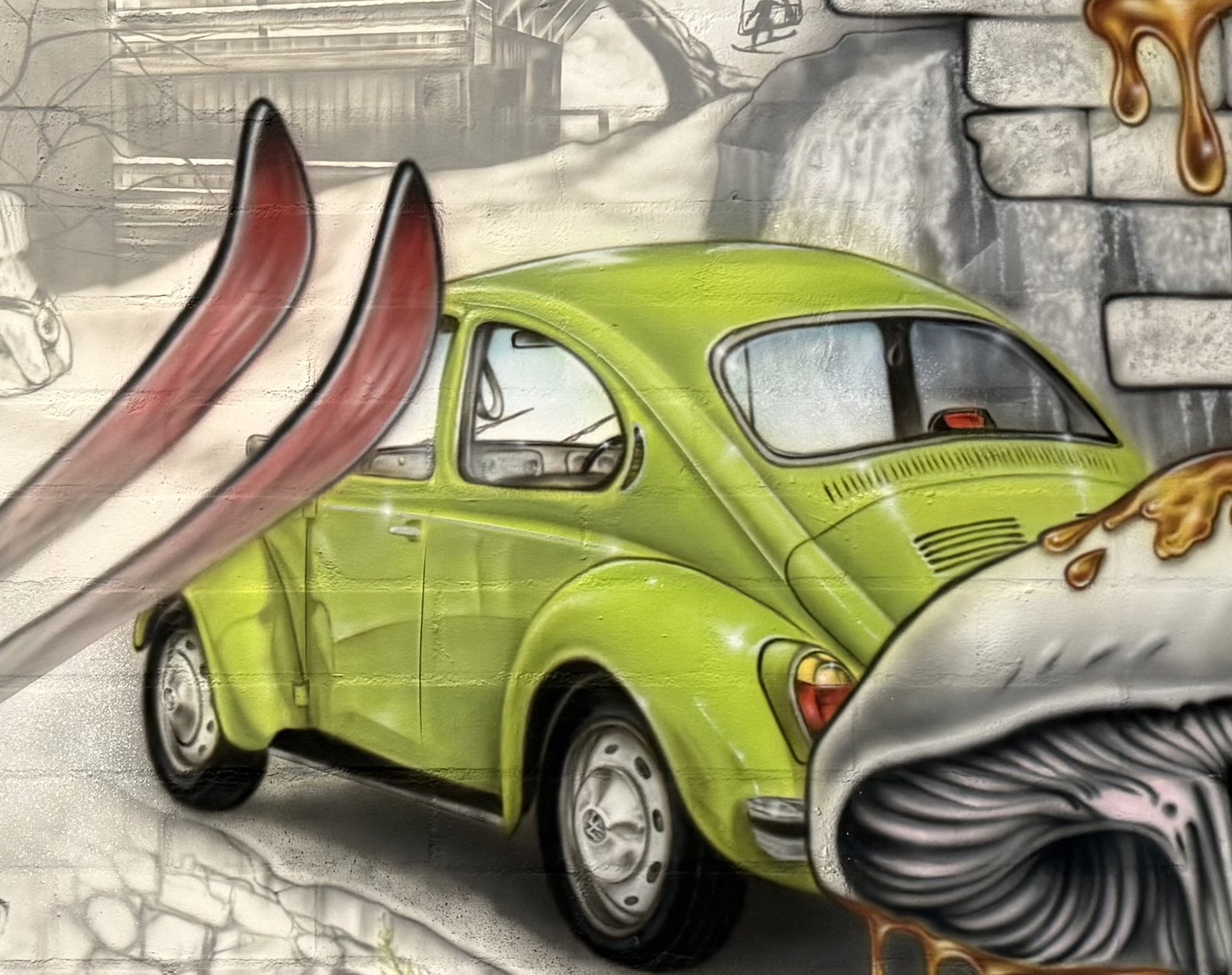 A green Volkswagen Beetle and a pair of red skis painted on the wall