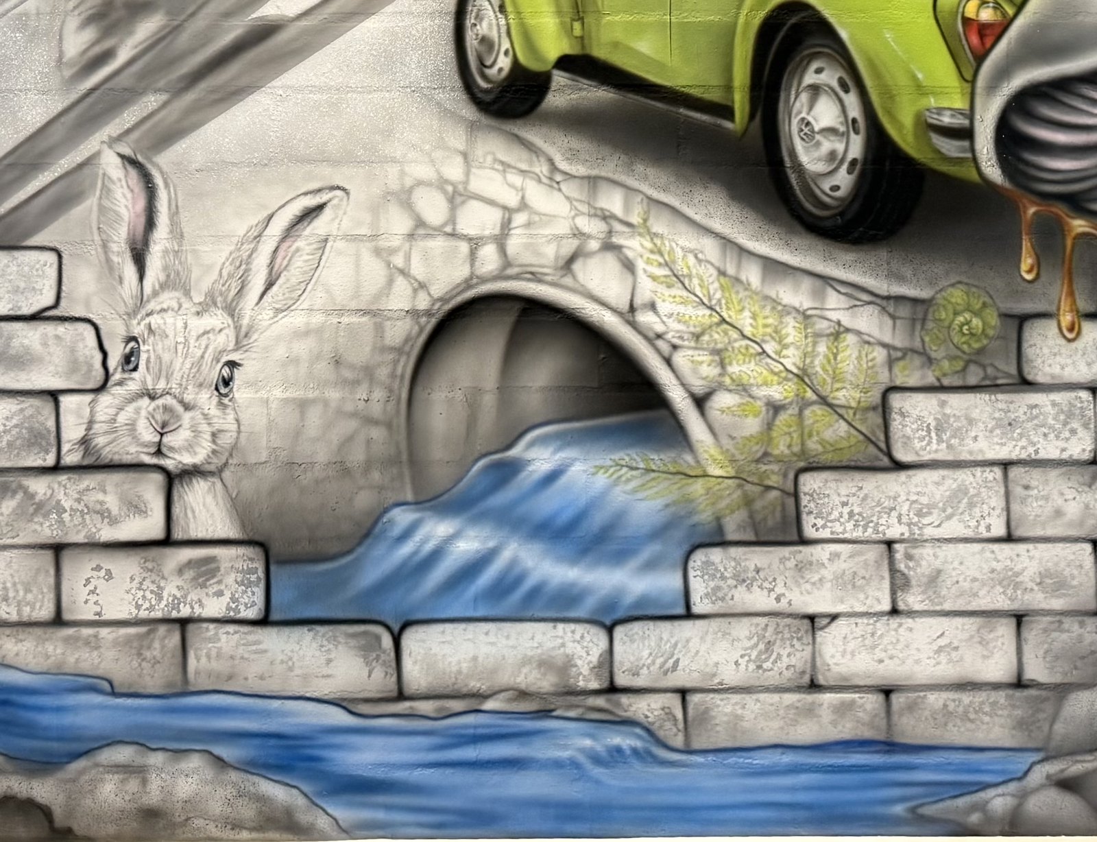 A hare beside a stone bridge with blue water running underneath